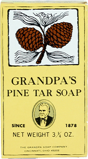 A yellow box of Grandpas Pine Tar Soap featuring an illustration of a pinecone branch at the top, text with product name and weight, and a small portrait of an older man near the bottom.