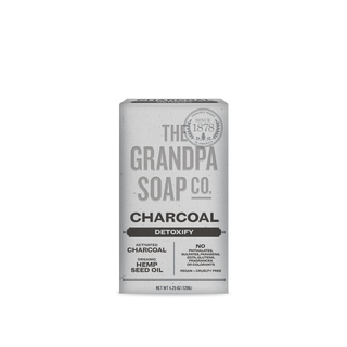 Charcoal Bar Soap with activated charcoal and organic hemp oil is ideal for oily skin. Its vegan, cruelty-free formula is free from sulfates and parabens, shown in white packaging with black text.